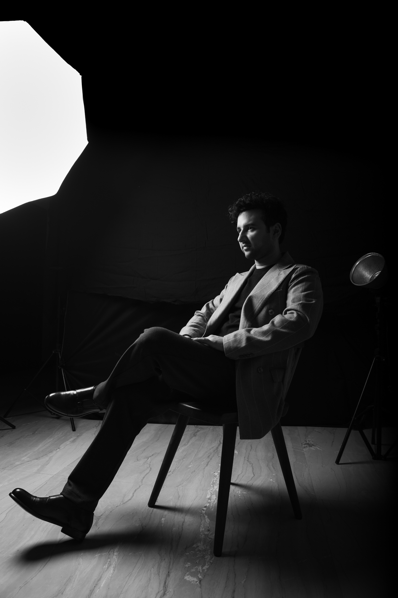 Viraj Bahri seated in a studio, black-and-white, softbox light overhead.